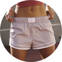 A woman wearing pink shorts.