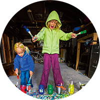 two children painting outside in winter apparel