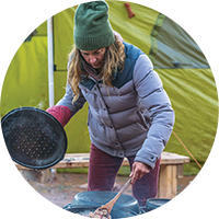 women cooking outside in cold weather apparel