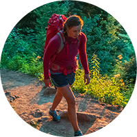 woman backpacking on trail