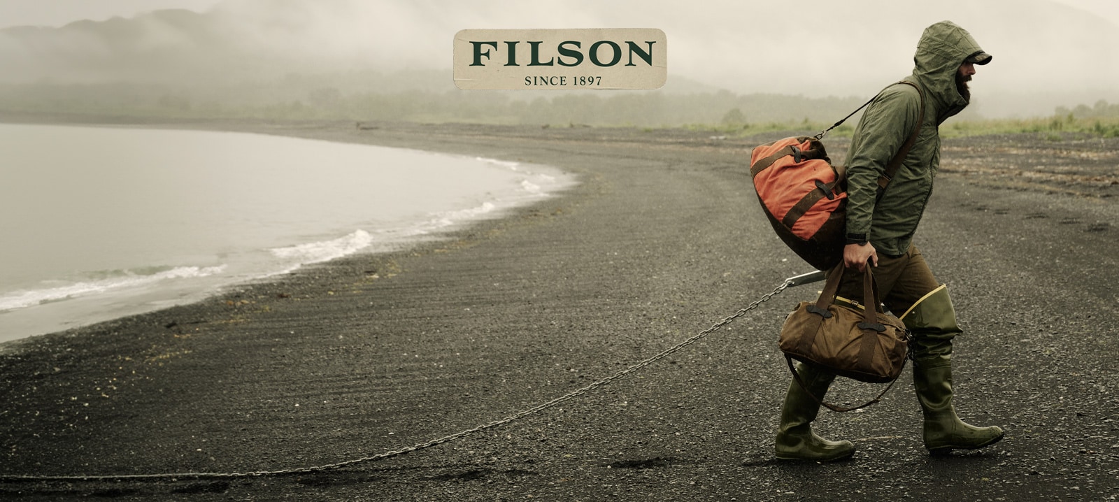 filson logo and man carrying filson bag