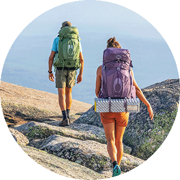 Two people backbacking through boulders