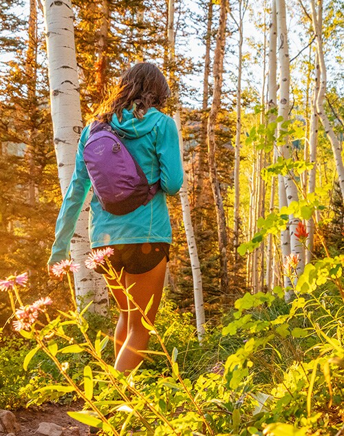 A woman hiking through the woods