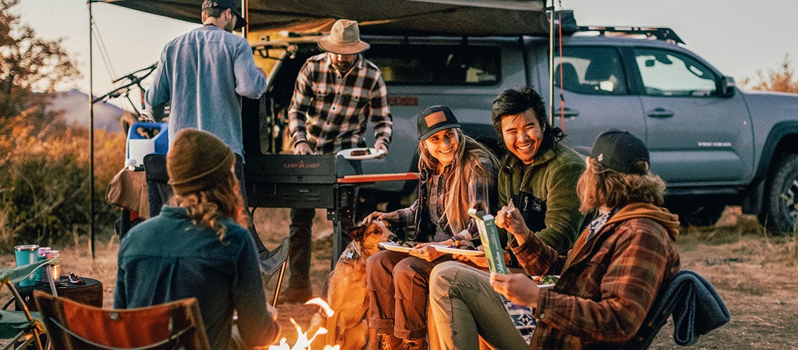 A group of friends sitting around a fire.