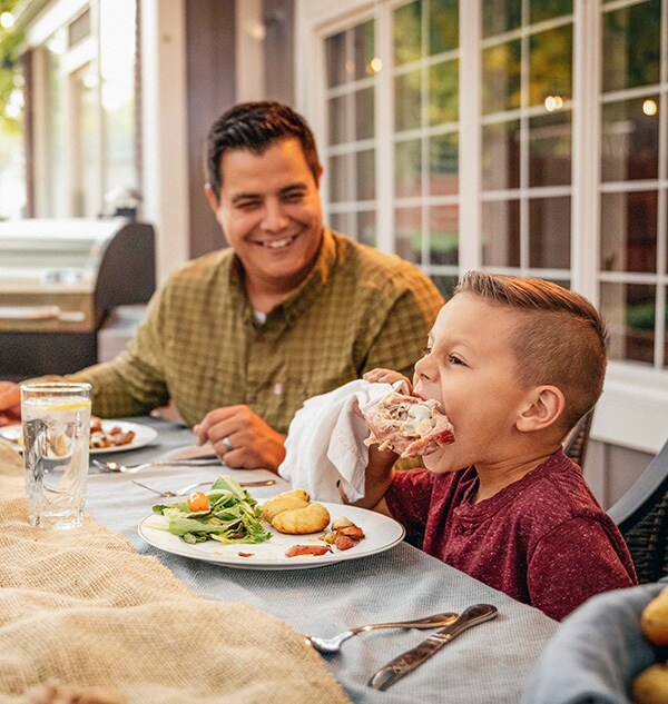 A child enjoying a cooked meal.