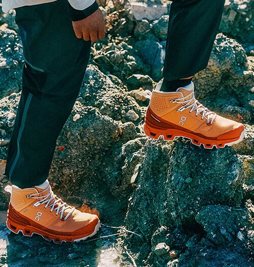 Man wearing ON hiking shoes.