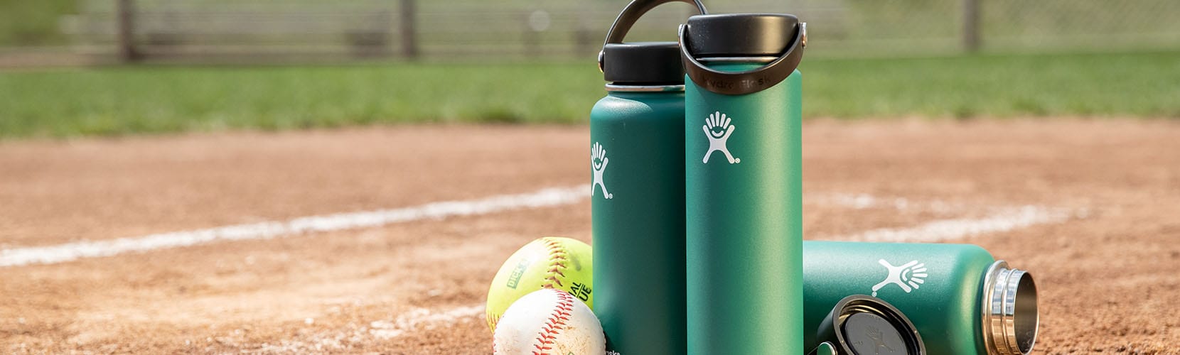 An image of water bottles and baseballs on a field.