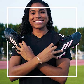 Image of athlete holding cleats