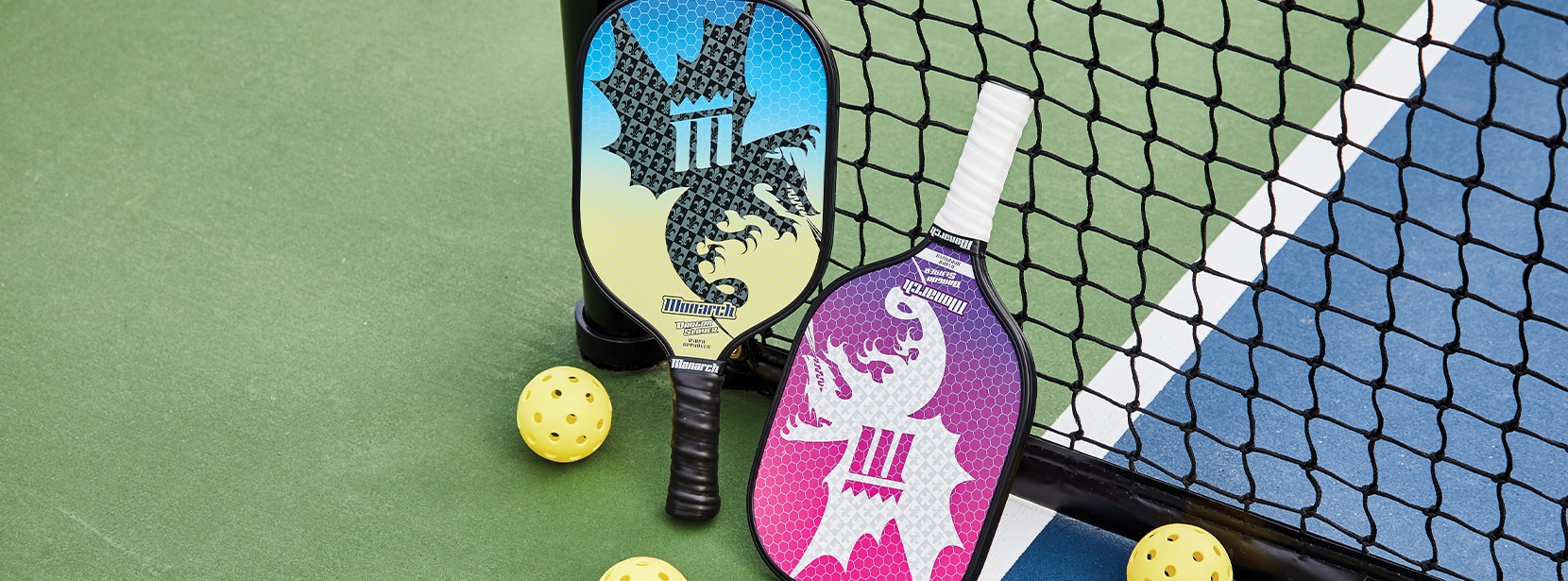 Image of Monarch pickleball paddles and balls on court