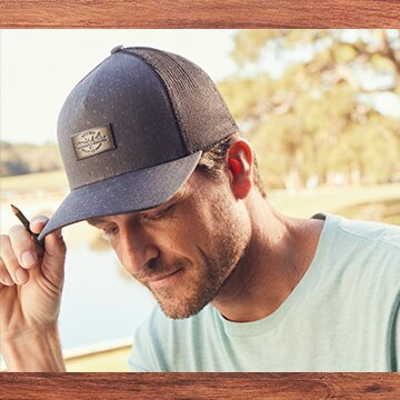 An image of a golfer wearing a TravisMathew hat.