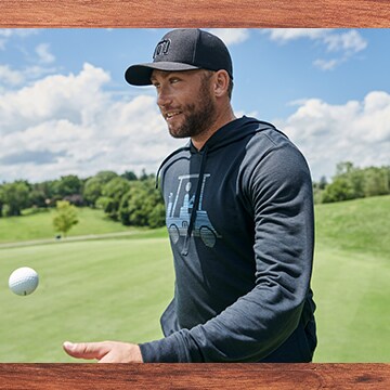 An image of a golfer wearing a TravisMathew hoodie.